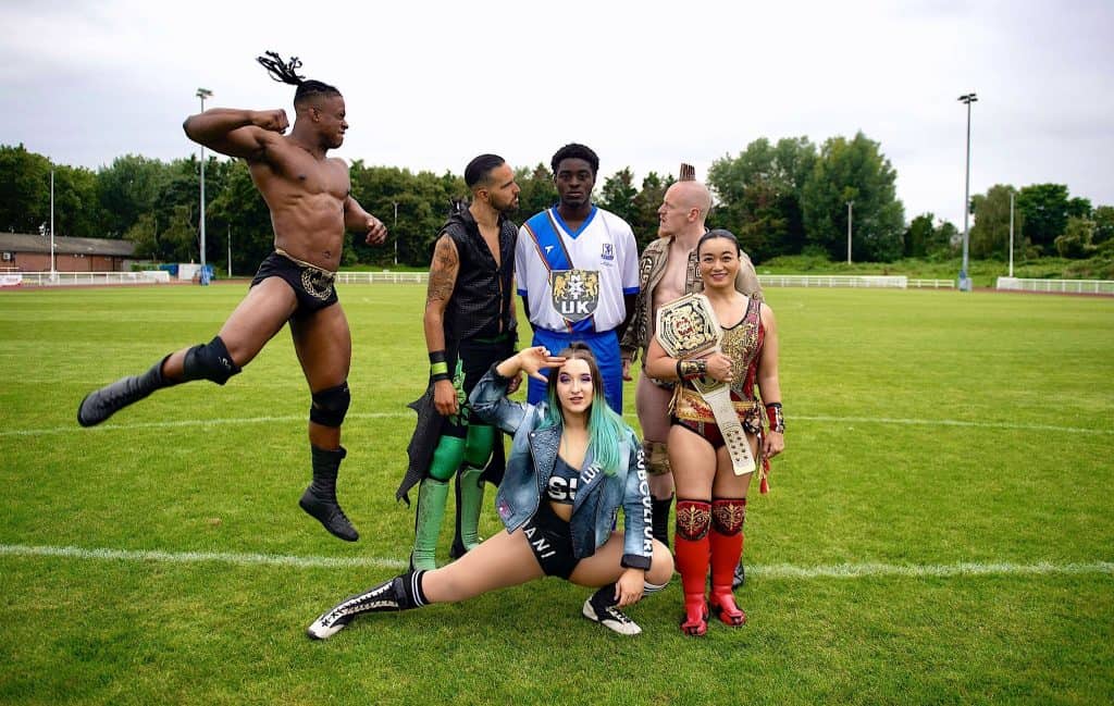 Enfield Town's babyface defender Jeremiah Gyebi falls victim to a sneak attack by NXT UK's dastardly heels at QE2 Stadium
