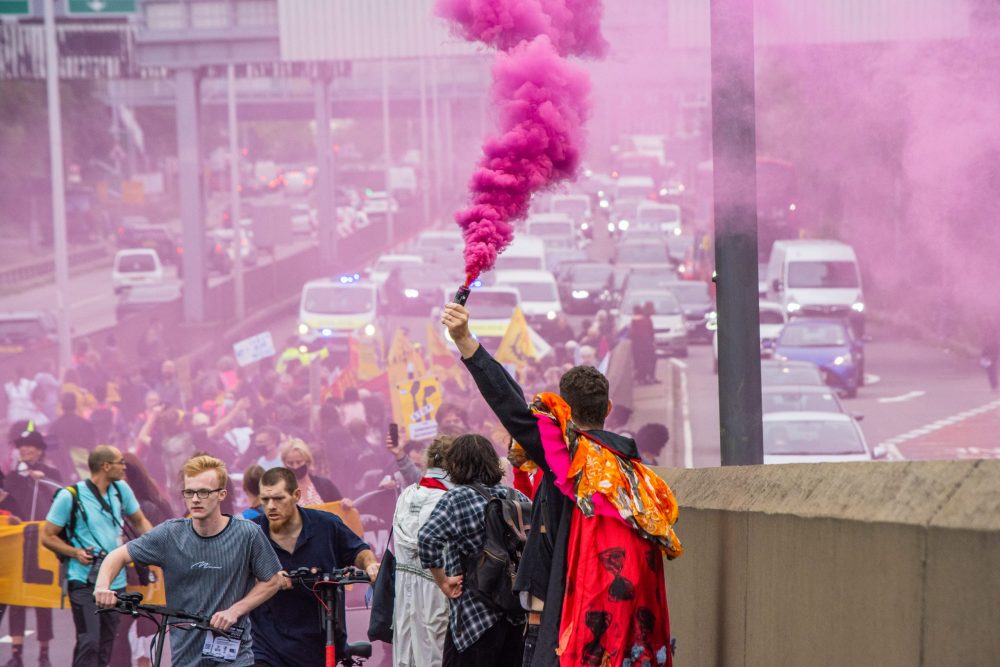 Pink flares were let off along the route of the protest march to Edmonton Eco Park, where a new incinerator is being built (credit Extinction Rebellion)