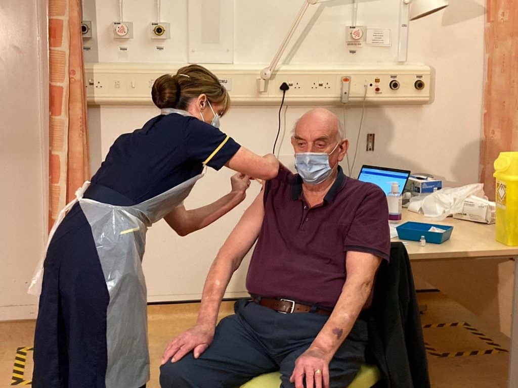 An elderly man receives a vaccine (credit NHS England)