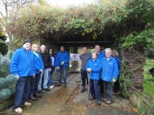 Volunteers from the Friends of Bury Lodge Gardens beside one of the four fenced-off pergolas that have become a health and safety hazard