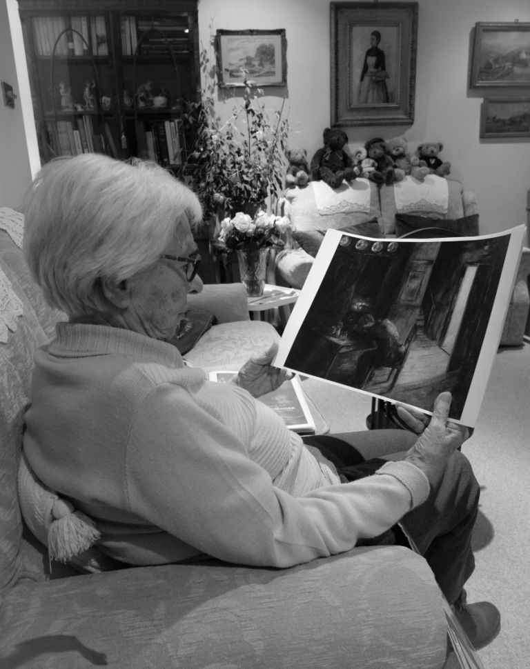 Eva Schloss looks at a print of a painting by her late brother Heinz - by Alex Sievers