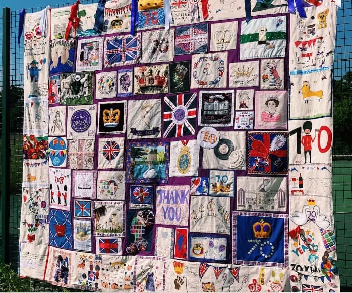 The finished 'Community Jubilee Collage' features 84 different stitched panels