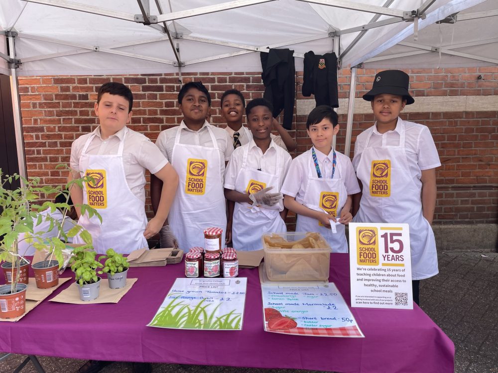 St Ignatius College pupils selling their school-grown veg at Enfield Market