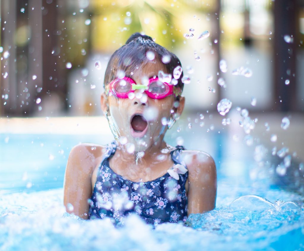 A girl swimming with goggles