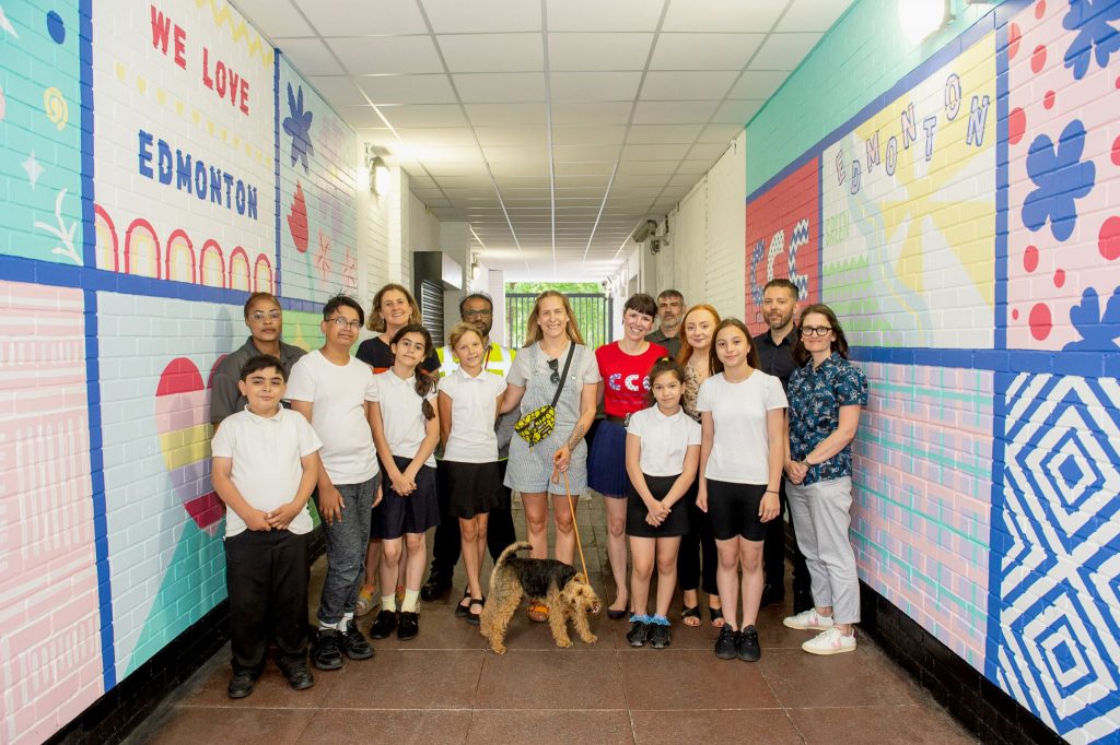 Pupils from Eldon Primary School with local artist Rose Hill, alongside the mural at Edmonton Green Shopping Centre (credit Toby Merritt)