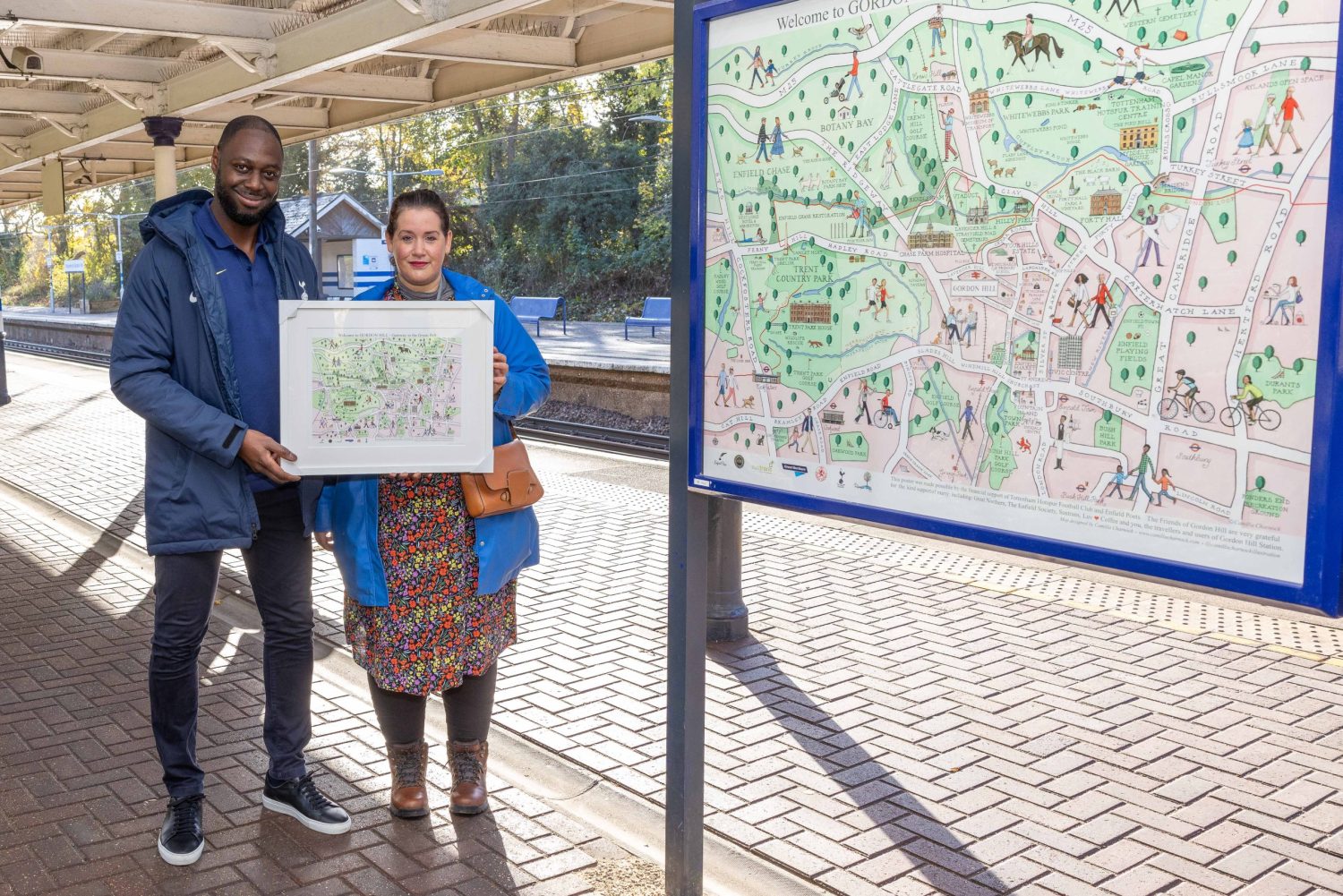 Ledley King is present with a framed copy of the community map by Whitewebbs councillor Hannah Dyson