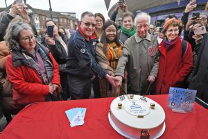 Enfield mayor Doris Jiagge cuts the 90th birthday cake for Southgate Station