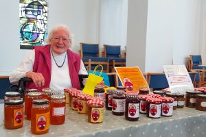 Margaret with a stand of her jam and marmalade at St Thomas's Church in Oakwood