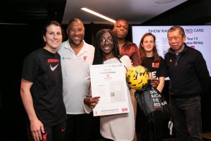 Shania Anyemedu receives her award from Show Racism the Red Card patron John Barnes