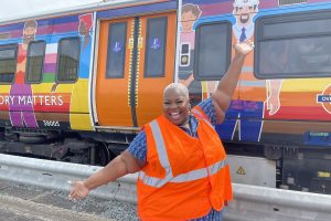 Queen Mojo with the Pride-decorated London Overground train (credit Noah Vickers/Local Democracy Reporting Service)