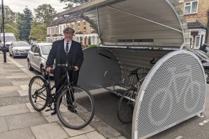 Cabinet member for environment Rick Jewell with the borough's 100th bike hanger