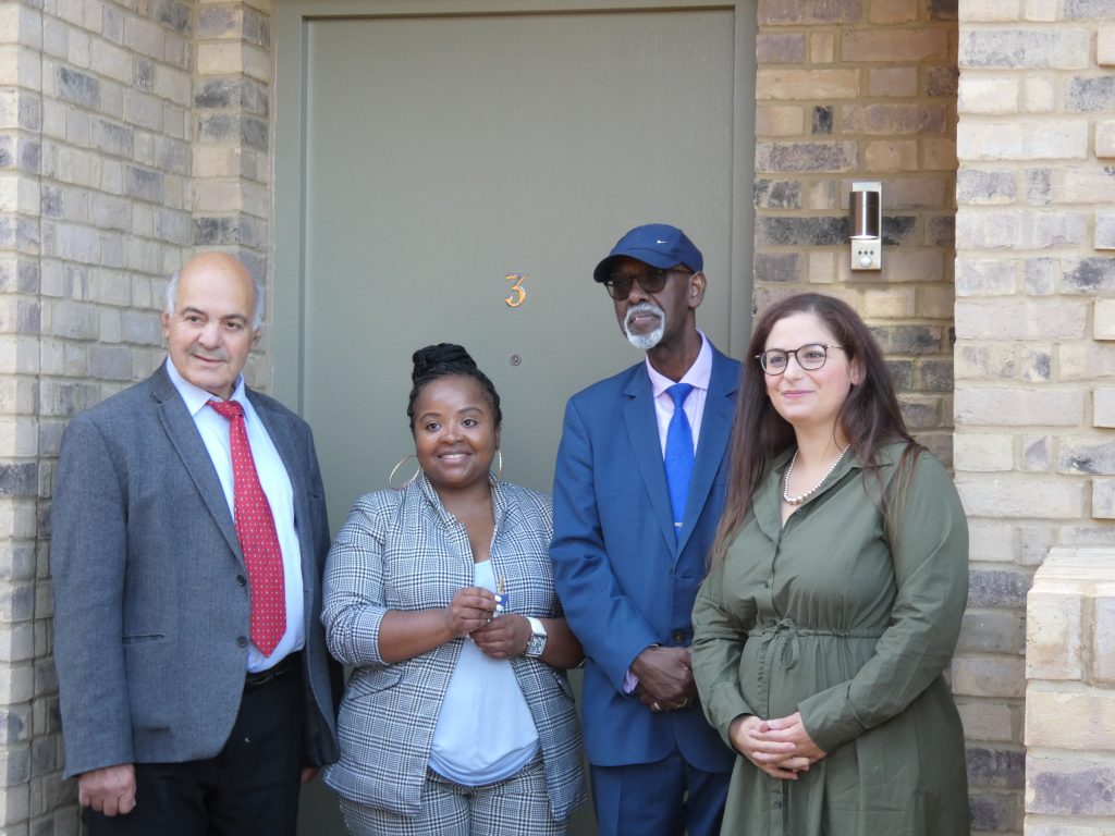 New Meridian Water residents Sandra Burity and Hussein Nur receive their keys from council cabinet member for housing George Savva (left) and leader Nesil Caliskan (right)