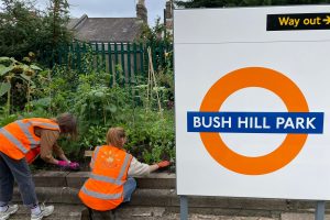 Volunteers get to work on the platform at Bush Hill Park Station