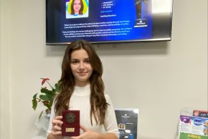 Melisa Deniz with her prize at Code Ninjas in Enfield