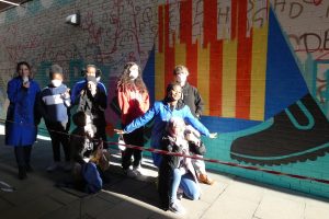 Art students from Enfield County School beside the mural as it begins to take shape
