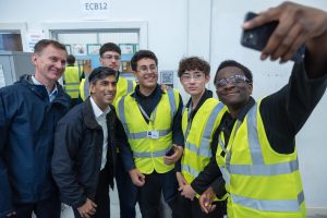 Rishi Sunak (second from left) and Jeremy Hunt (left) pose for a selfie with Enfield students