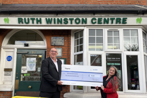 Andrew Ingram, managing director of TG Lynes (left) presents Maria Ortiz Vega from Ruth Winston Community Centre with a £10,000 cheque