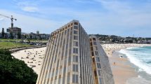 Bondi Beach in Australia (credit Ank Kumar) and (inset) Enfield Civic Centre