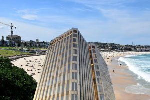 Bondi Beach in Australia (credit Ank Kumar) and (inset) Enfield Civic Centre