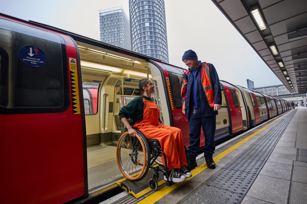 A wheelchair user exiting a tube train using a ramp