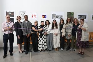 Students help cut the ribbon on the exhibit