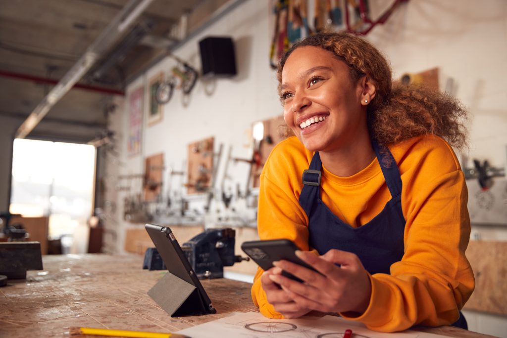 A smiling woman behind a counter