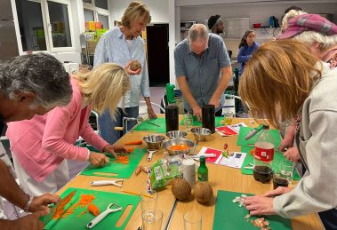 Visitors to the community kitchen in Ponders End get chopping