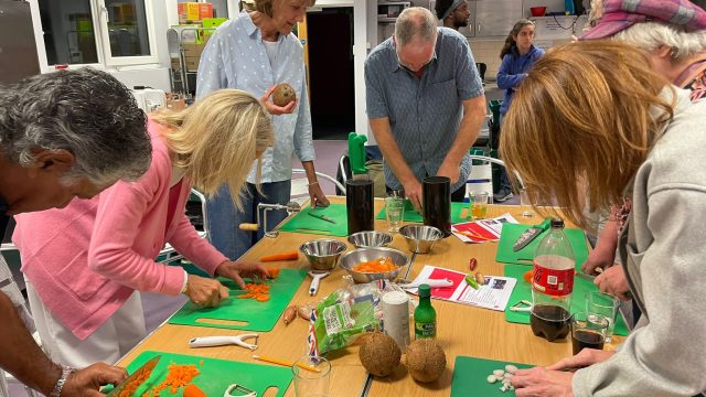 Visitors to the community kitchen in Ponders End get chopping