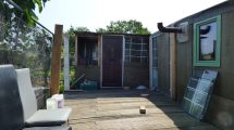 Many structures at Barrowfield Allotments have windows, doors and chimneys