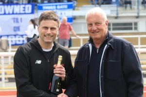 Gavin Macpherson receives a bottle of bubbly from Rick Howlett of sponsors Vanderpump Sykes (credit Phil Davison)