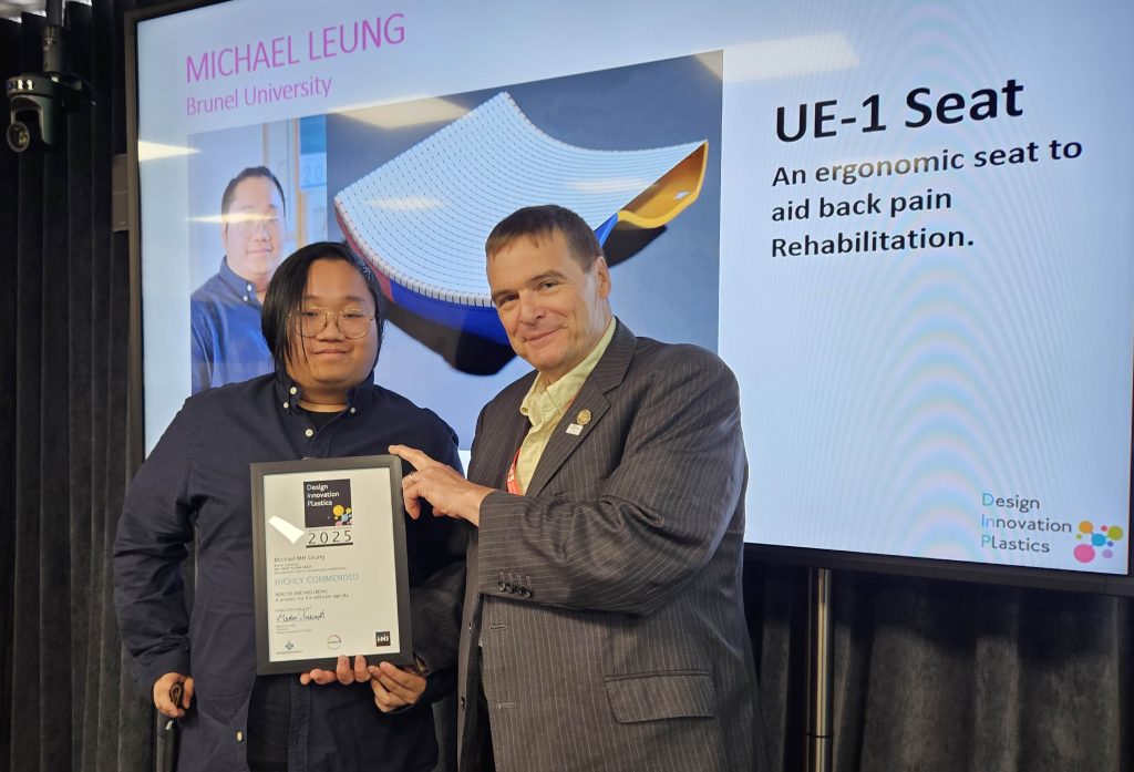 Michael Leung is presented with his certificate by Dr Colin Church