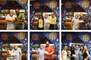 Some of the charities receiving cheques from Edmonton Rotary Club president David Littleton