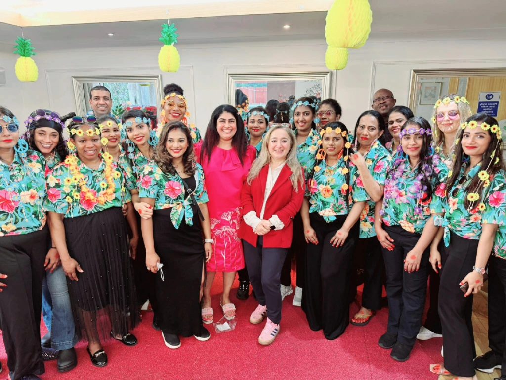 Feryal Clark MP (centre right, in red jacket) joins Albany Park Nursing Home for its summer event