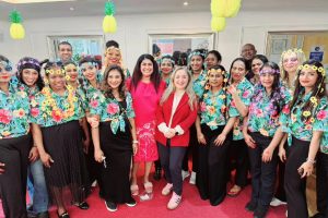 Feryal Clark MP (centre right, in red jacket) joins Albany Park Nursing Home for its summer event