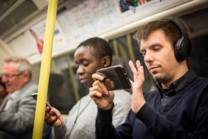 Using headphones on the tube (credit TfL)