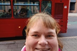 Zoe White with the bus advert promoting Enfield BIPC