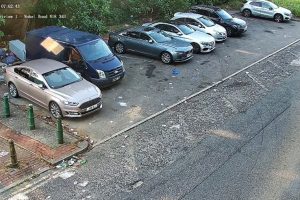 A CCTV still of the van (dark blue) caught in the act of fly-tipping