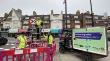 Cabinet member Sabri Ozaydin helps install new 20mph signs in Palmers Green (credit Enfield Council)