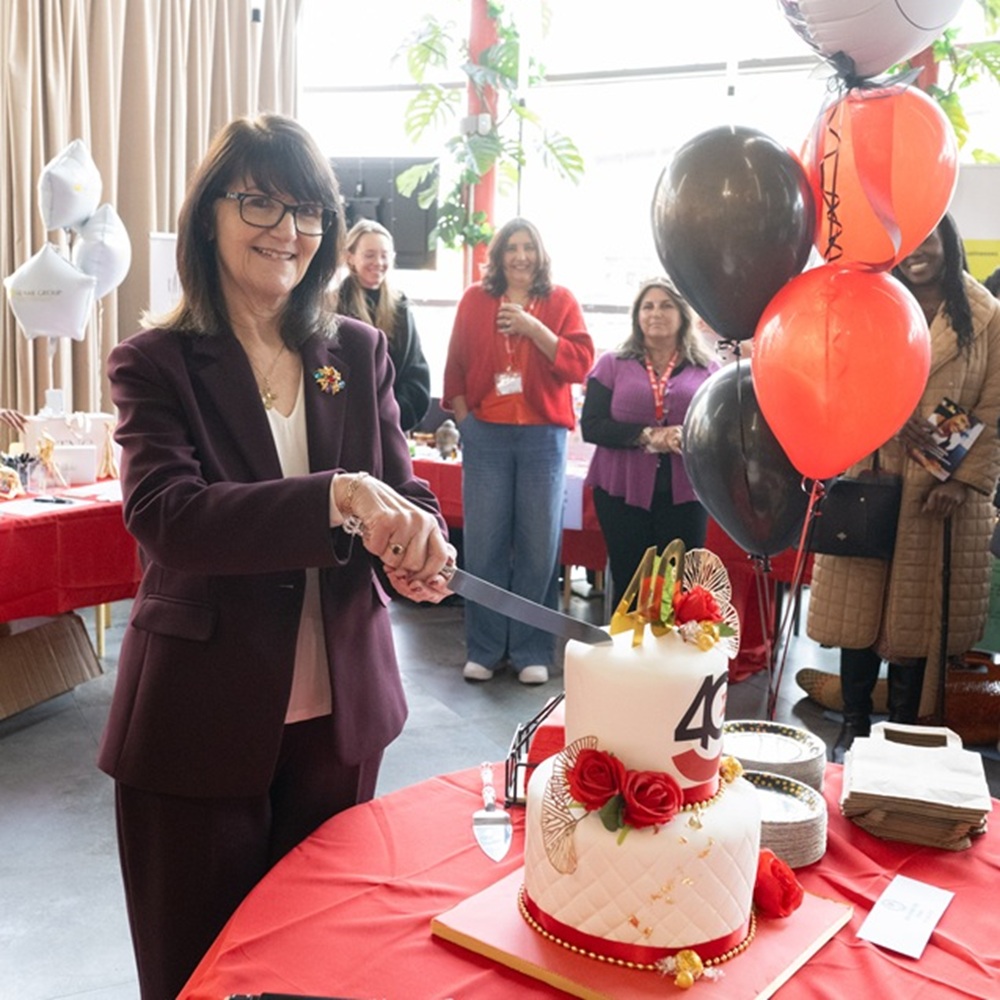 Despina Johnson, CEO of Enterprise Enfield, cuts the 40th birthday cake