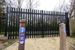 A large padlocked gate currently blocks access to the remaining part of the New River walking and cycling route
