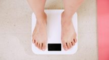 a pair of feet stand on some bathroom scales