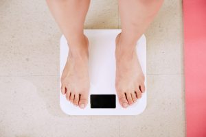 a pair of feet stand on some bathroom scales