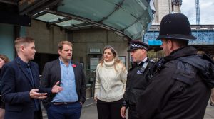 Lib Dem MP and London spokesman Luke Taylor (with blue shirt) speaks to Met Police officers (credit London Lib Dems)