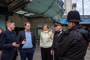 Lib Dem MP and London spokesman Luke Taylor (with blue shirt) speaks to Met Police officers (credit London Lib Dems)