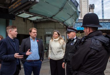 Lib Dem MP and London spokesman Luke Taylor (with blue shirt) speaks to Met Police officers (credit London Lib Dems)