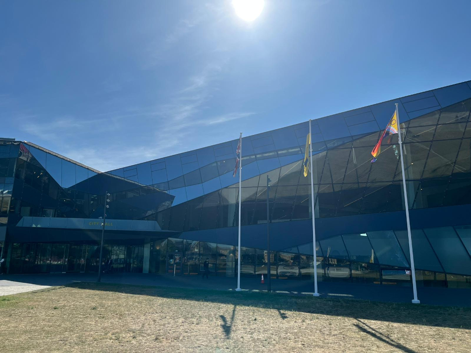 Three flags flying outside the headquarters of the Greater London Authority