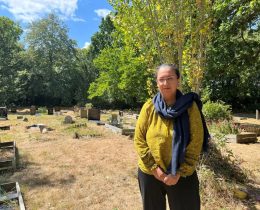 A woman standing in a cemetery