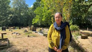 A woman standing in a cemetery