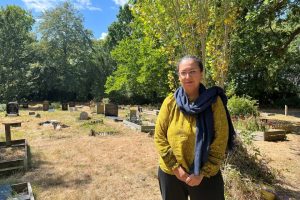 A woman standing in a cemetery
