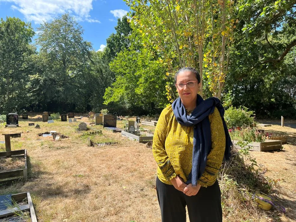 A woman standing in a cemetery 